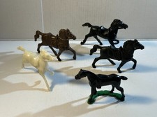 Lot of five assorted plastic Western horses from different playsets.