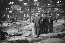 8" x 10" Farmers waiting for tobacco to be sold at auction in warehouse