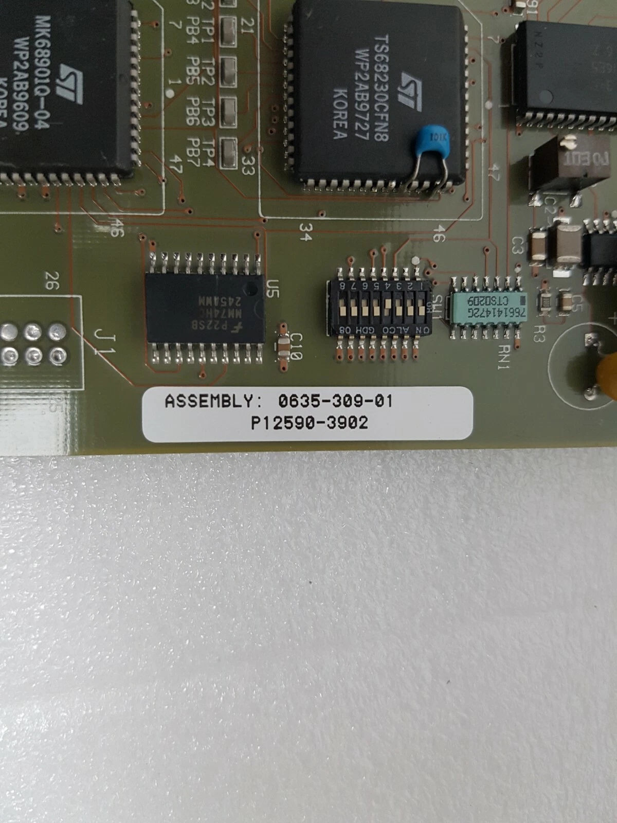 Sticker ASSEMBLY 0635-309-01, P12590-3902 beside the DIP switch