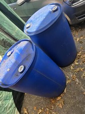 Large blue plastic oil drums, ideal for turning into DIY planters, dock floats.