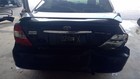 Black Toyota Camry rear bucket passenger retractor with red tail light, black plate number 224108, and visible Toyota logo.