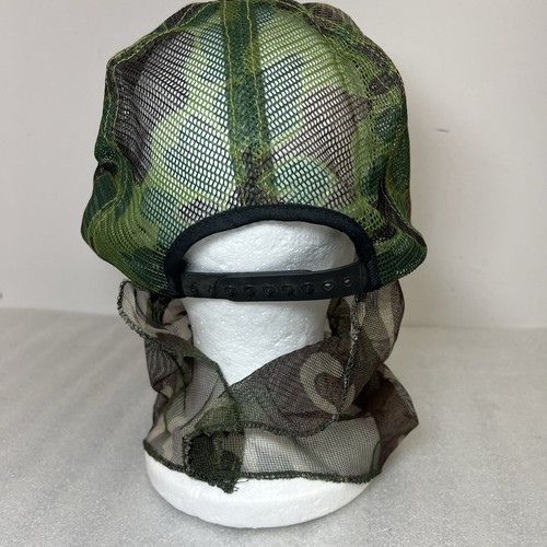 Green and brown camouflage Vtg hat with mesh front and black snapback, displayed on white mannequin head.