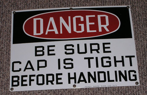 porcelain sign DANGER BE SURE CAP IS TIGHT BEFORE HANDLING looks new unused