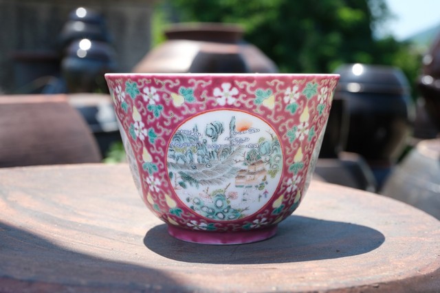 0197 A ruby-ground famille-rose figural bowl, Late Qing