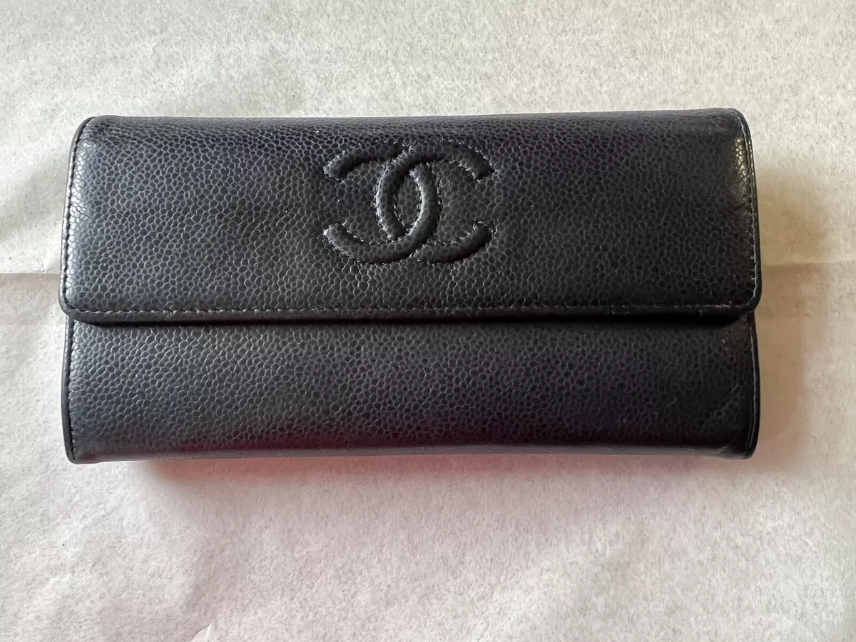 100% authentic Pre-Owned Chanel L-Flap wallet. Black leather.