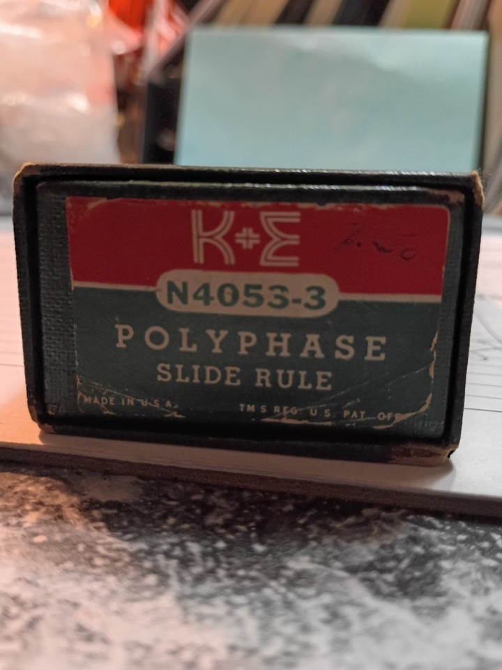 A classic K&E Polyphase slide rule with its original sleeve case — a clean, complete example of the tool that put humans in space before silicon chips existed.
