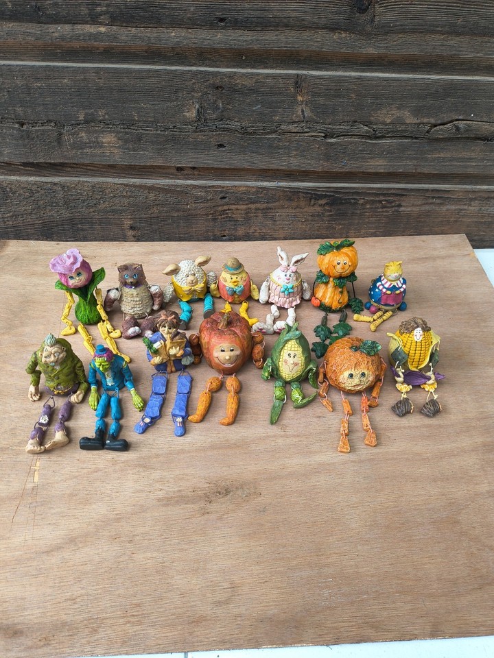 A whole gang of whimsical anthropomorphic resin characters — the kind of weird, charming shelf decor that sparks instant conversation.