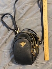 Black Leather Crossbody Bag with Gold Bee Emblem and Three Zippered Compartments