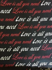 LOVE IS ALL YOU NEED fabric red/white script on black -15" x 22"  remanat