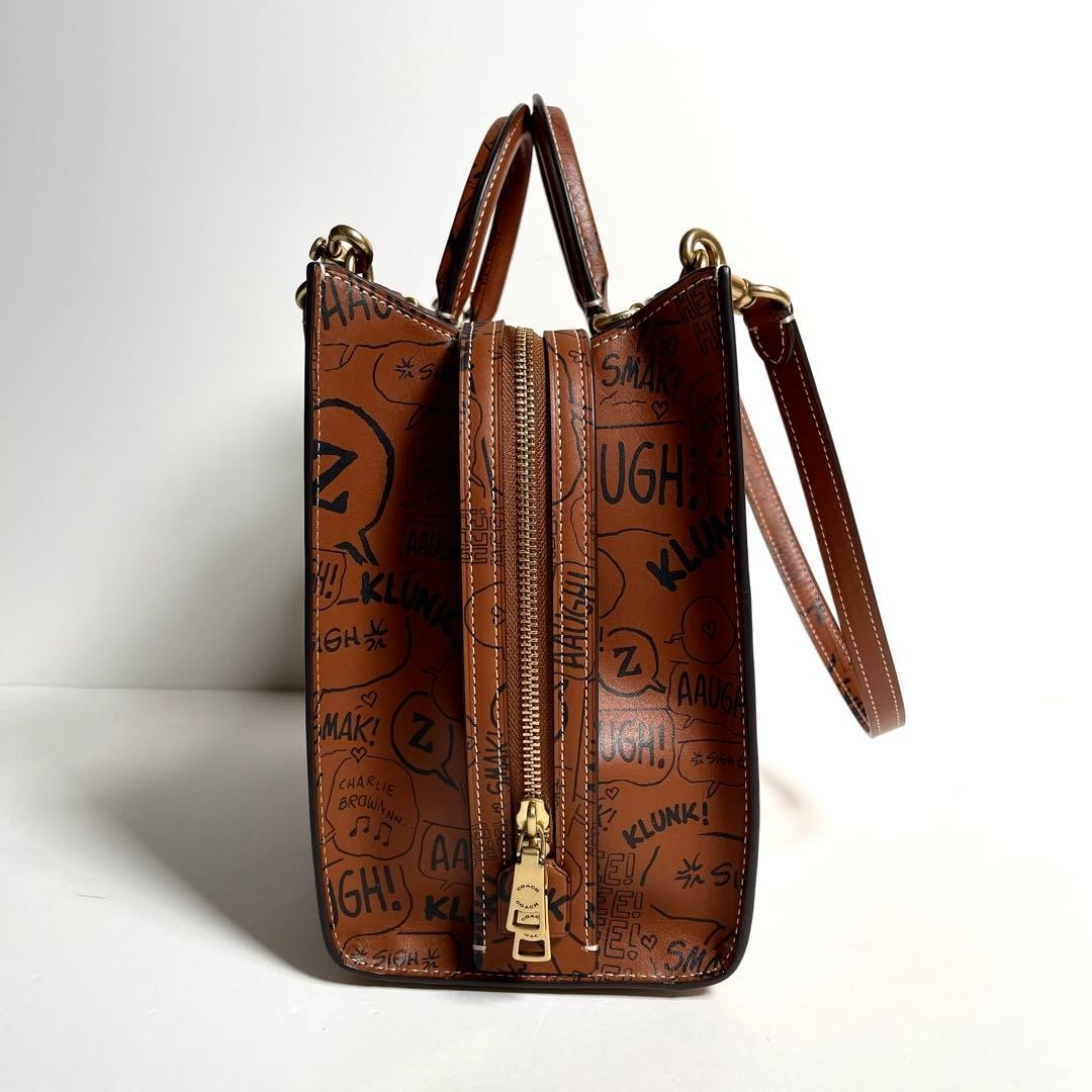 COACH x PEANUTS LIMITED EDITION HAZELNUT NEWSPRINT SNOOPY ROGUE