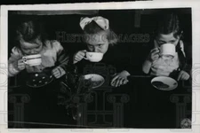 1947 Press Photo 3 children drinking hot cocoa during the Christmas party