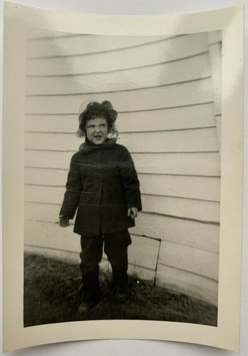 Vintage 1940s Snapshot of Young Grumpy Girl Outside Posing against a House