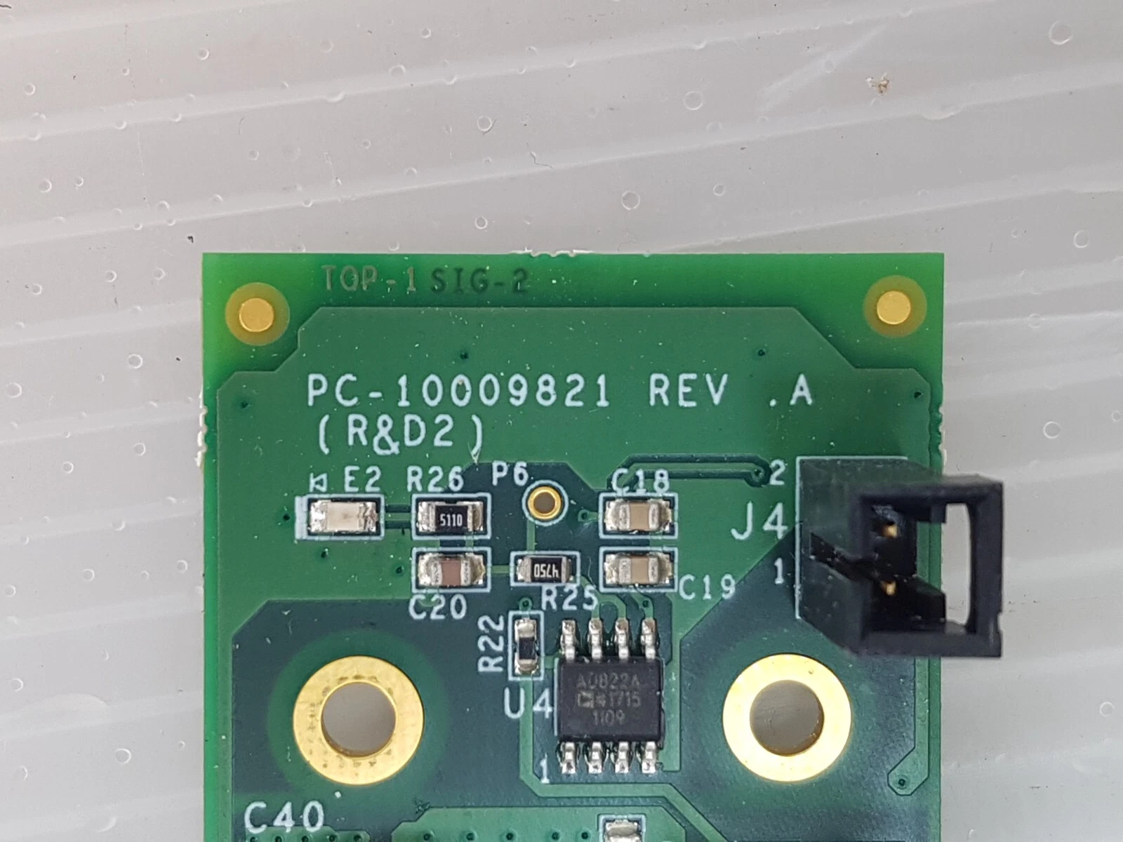 Silkscreen close-up: PC-10009821 REV .A (R&D2) beside header J4