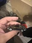 Vintage 1982 Hot Wheels Black Ford Escort XR3 diecast car with orange pinstripes