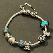 GENUINE PANDORA SOLID SILVER CHARM BRACELET WITH EIGHT CHARMS