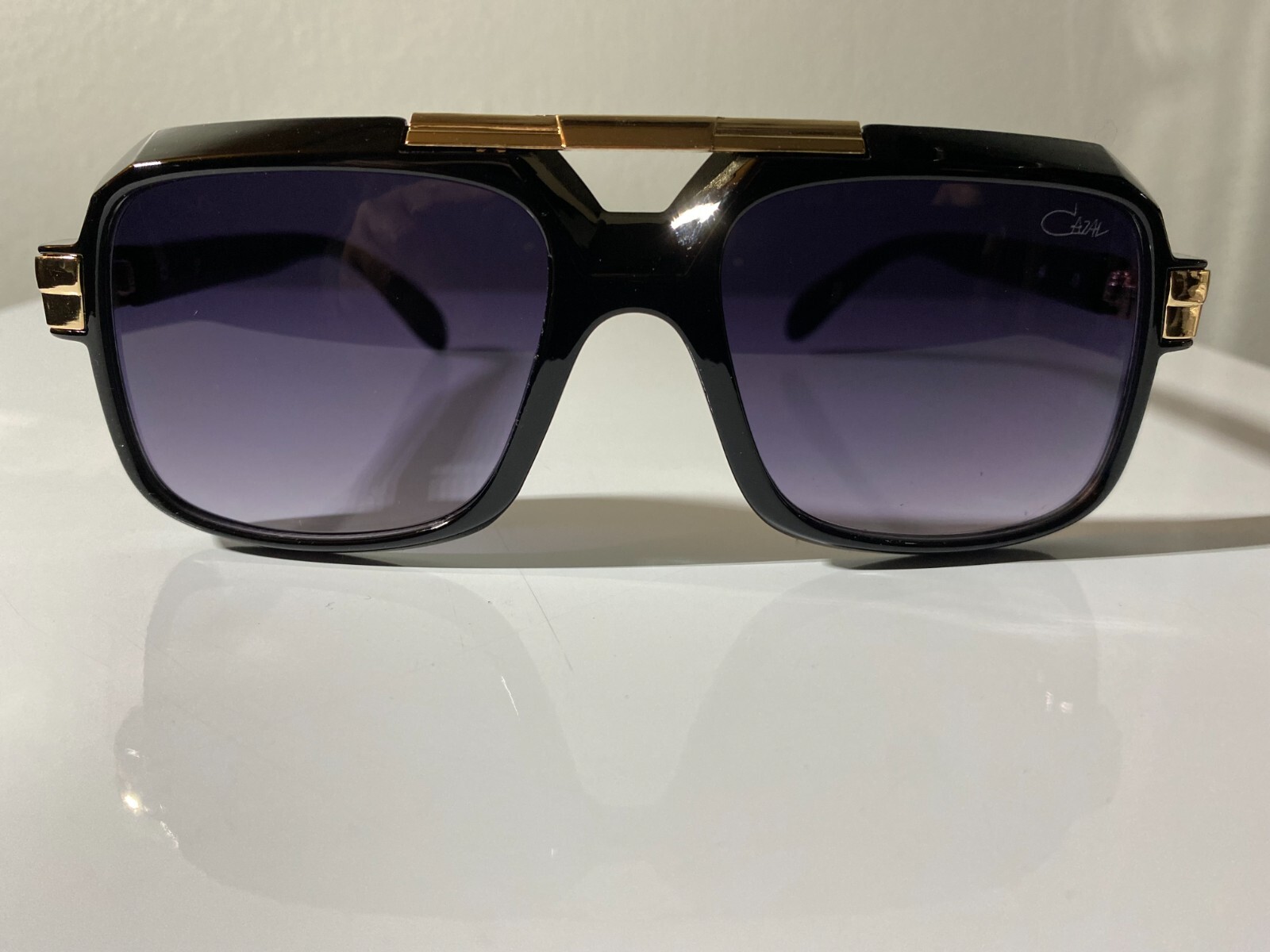 Vintage style men's sunglasses with black frame and purple tinted lenses