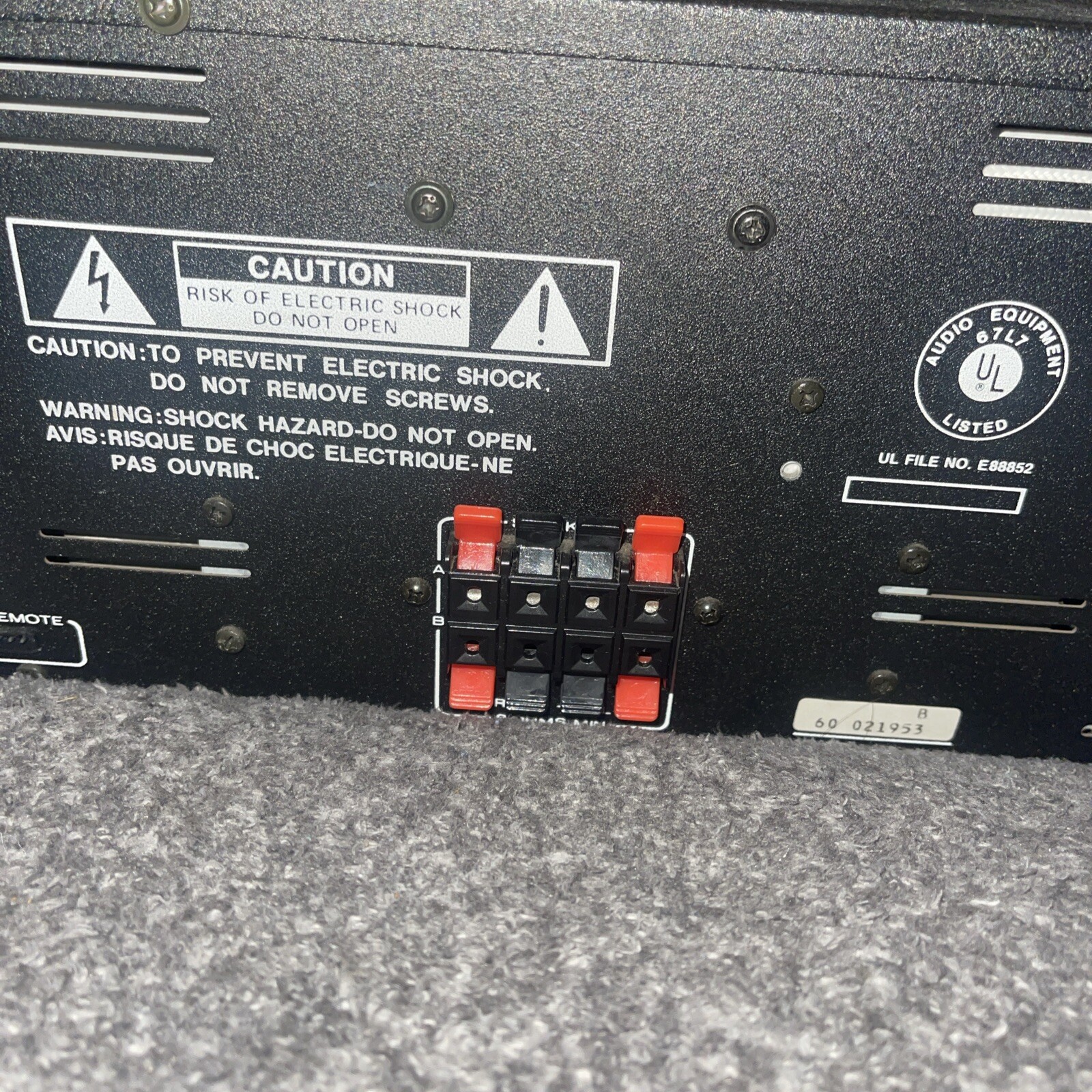 Back panel of Marantz ST-100 tuner and PM100 amplifier with caution labels, red and black terminal blocks, and gold UL badge.