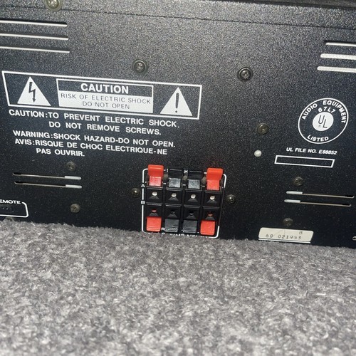 Back panel of Marantz ST-100 tuner and PM100 amplifier with caution labels, red and black terminal blocks, and gold UL badge.
