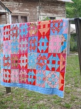Vintage handmade cotton quilt featuring Churn Dash and Star pattern blocks