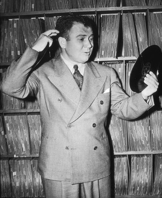 British born jazz radio disk jockey Al Jarvis poses while holding - Old Photo