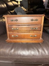 vintage wooden jewelry box with three drawers and ornate metal handles