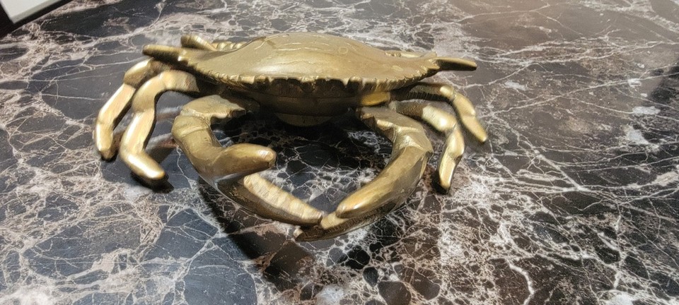 A brass crab inkwell — because why have a boring pen cup when you can have a crustacean guarding your desk?