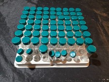 Lot of 60+ glass vials / test tubes with screw caps in holder