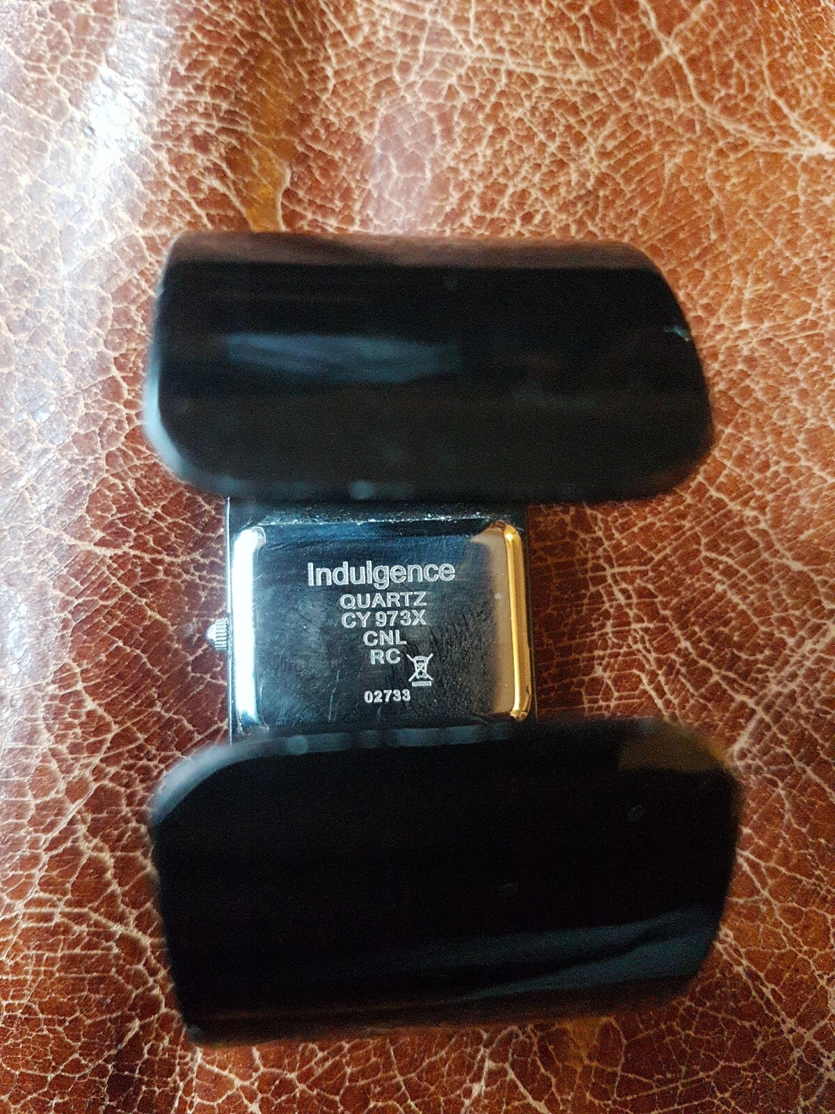 BNIB INDULGENCE Ladies watch solid sprung black metal strap silver face