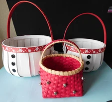 THREE CHRISTMAS GIFT BASKETS ARE SNOWMEN THEMED AND RED WITH JINGLE BELLS
