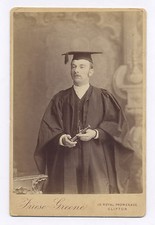 CABINET PHOTO OF GRADUATE, MAN HOLDING A SPYGLASS & WEARING A MORTAR BOARD HAT