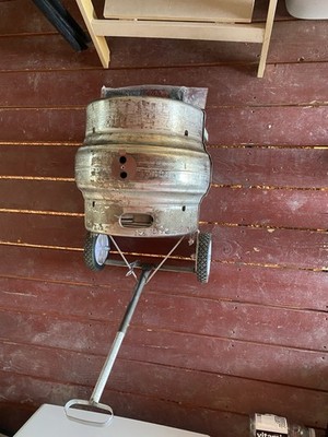 Custom charcoal grill made from a half-size beer keg mounted on a wheeled cart