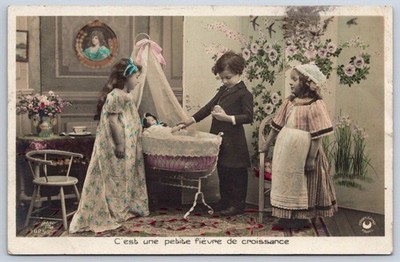 Antique French postcard children admiring baby in crib 1900s