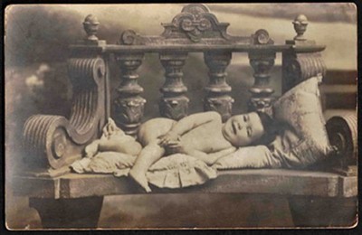 Cutest Smiling Toddler Laying on Pillows on a Bench 1900s Cabinet Photo Postcard