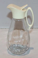 vintage 7 1/4" clear glass syrup dispenser pitcher with plastic top Log Cabin?