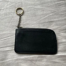 Black leather coin case with keychain, zipper, brand logo used