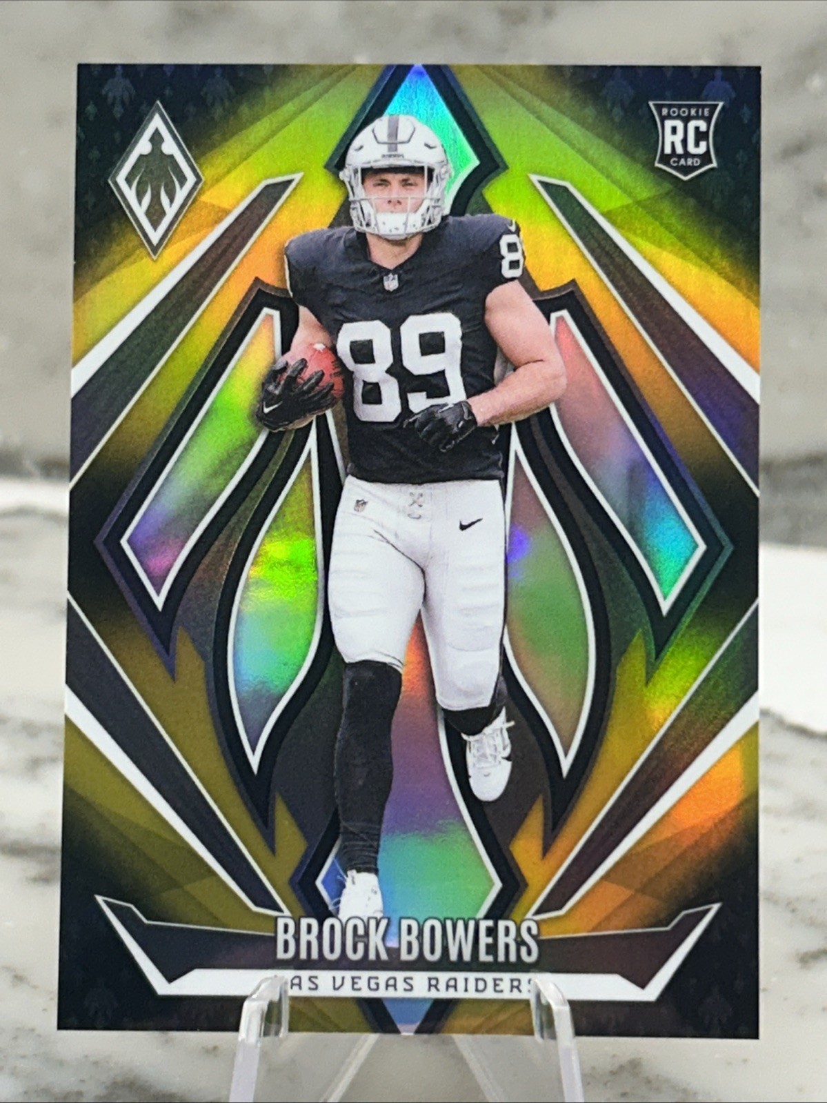 2024 Panini Phoenix - Rookies Brock Bowers #165 Gold Fade /125 (RC)