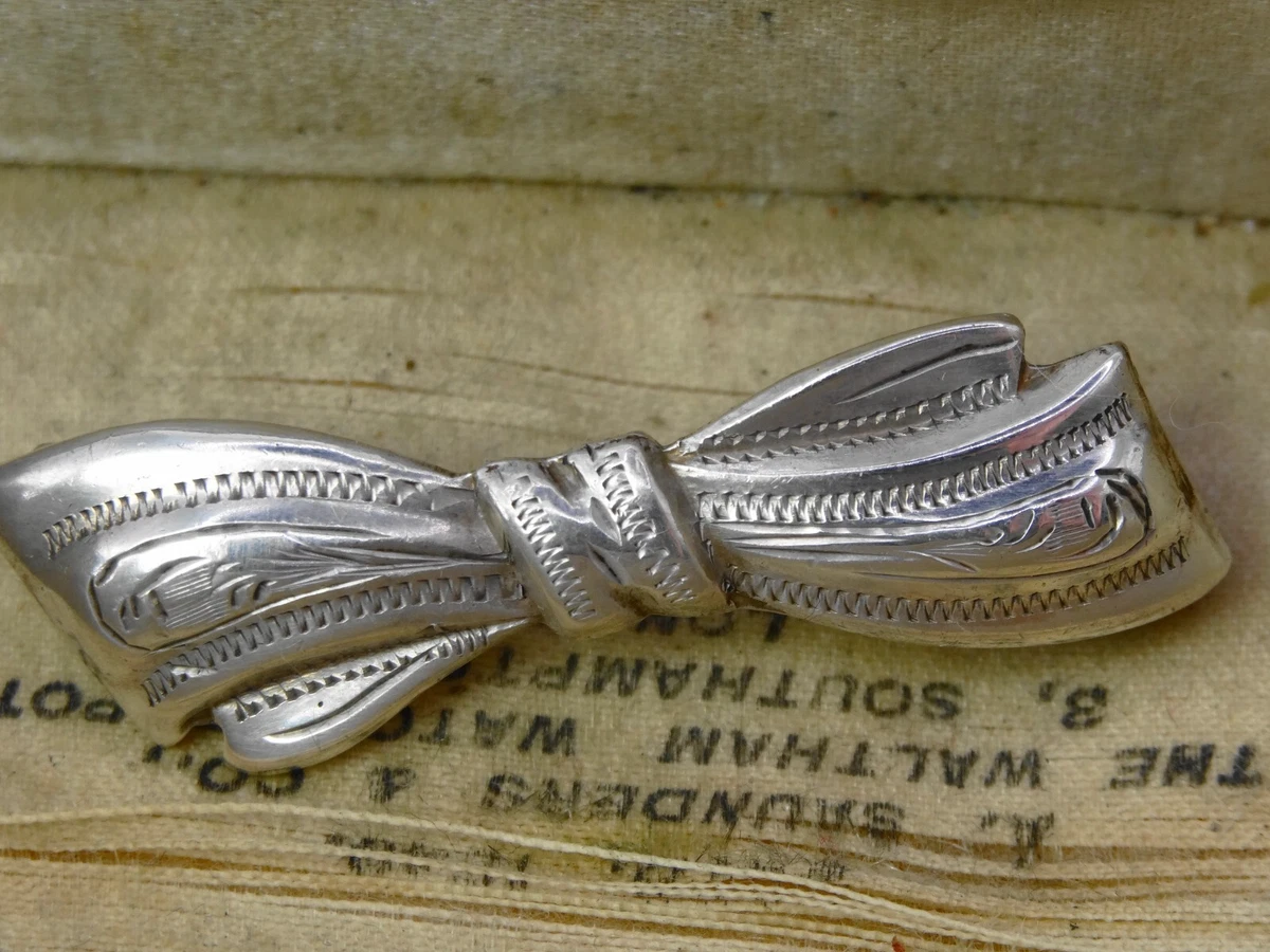 Antique sterling silver engraved bow brooch