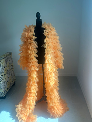 Orange tulle with voluminous ruffles. Dramatic, lightweight statement access. XL