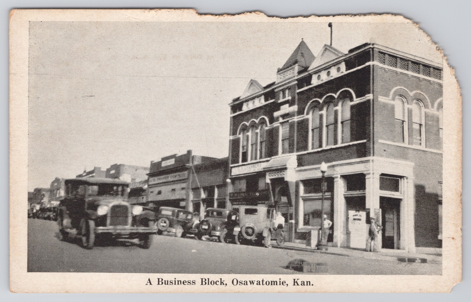 A BUISNESS BLOCK, STREET SCENES IN OSAWATOMIE KANSAS OLD CARS PARKED KS