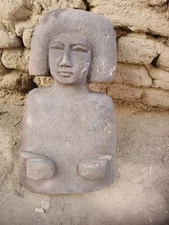 Ancient egyptian antique wooden sculpture with distinctive hair, primitive style