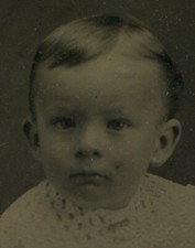 YOUNG CHILD, BOY WEARING STRIPED SOCKS. TINTYPE.