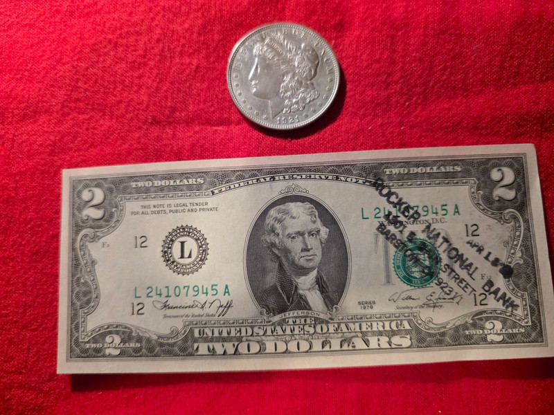 1921 PEACE SILVER DOLLAR AND A US $2 BILL 1976 SERIES DATE STAMPED BY BANK
