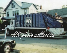 2 fotos a color de camión de basura BFI de 2004 cargador trasero de lixiviación