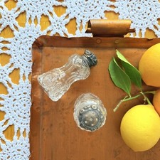 Antique fancy cut glass salt and pepper shakers .