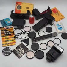Lot of Assorted Camera Filters Caps Flashes Manuals Parts etc.