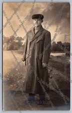 Antique RPPC portrait young man in overcoat and cap Real Photo Postcard 