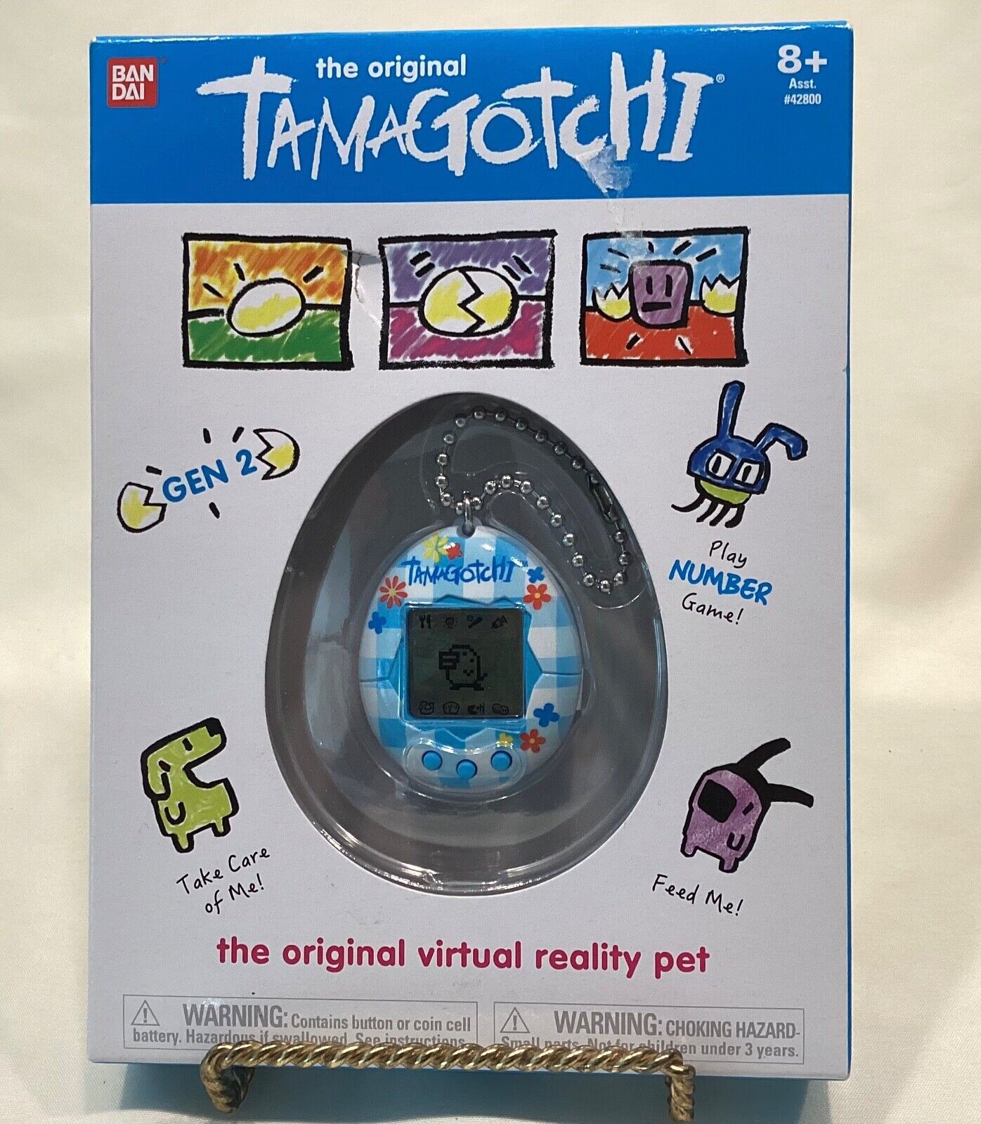 TAMAGOTCHI 42880 Bandai, Gen 2, Flower Gingham Shell with Chain-The  Original Virtual Reality Pet, Multicolor