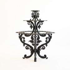 Victorian black cast iron three tier plant stand, with floral decoration