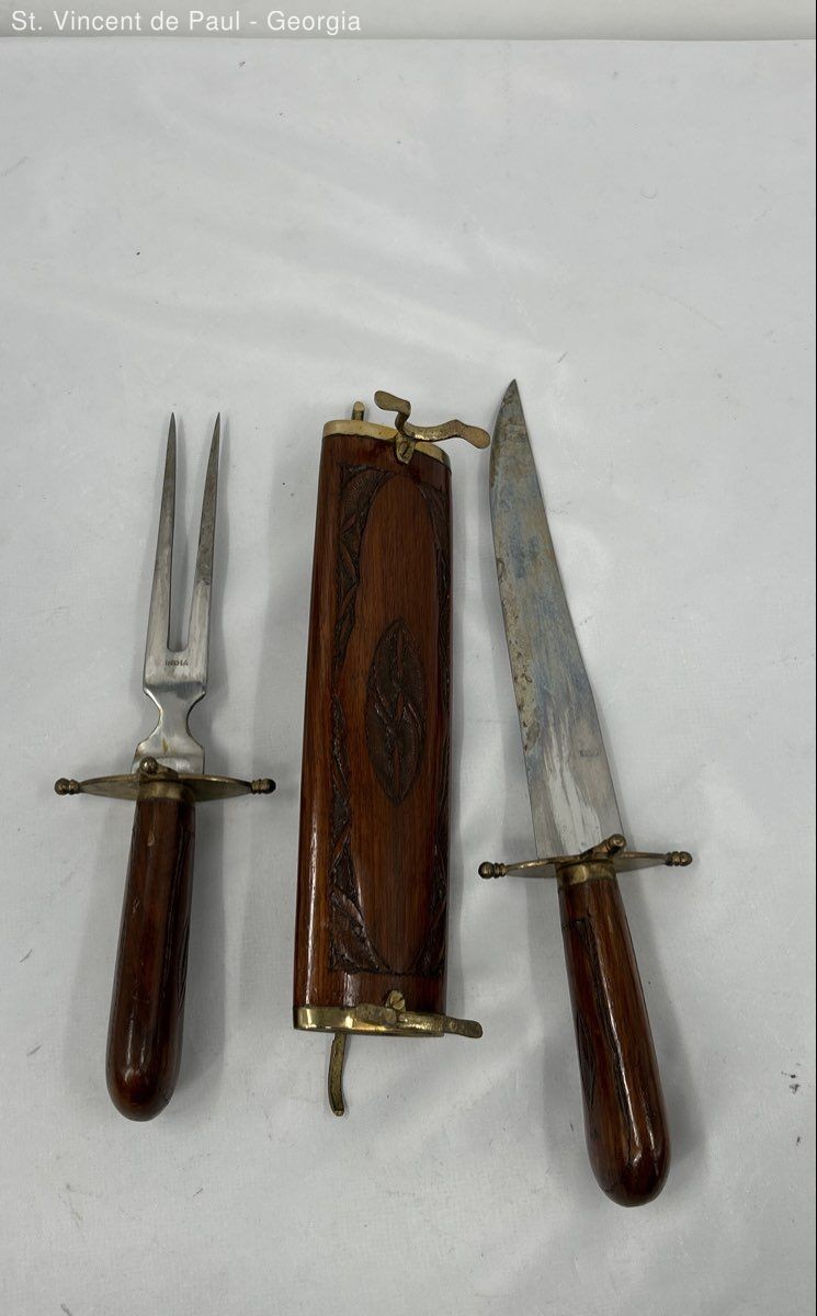 Vintage carving knife and fork set with carved wooden handles and matching wood sheath.
