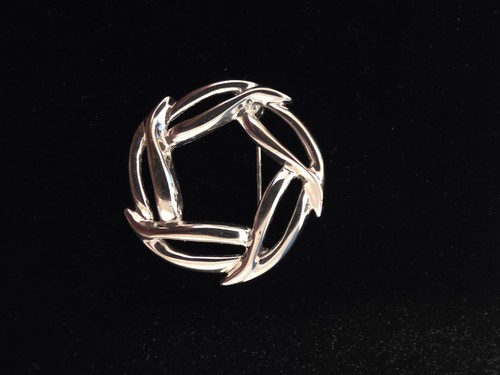 A vintage signed Napier brooch featuring a bold geometric circular design